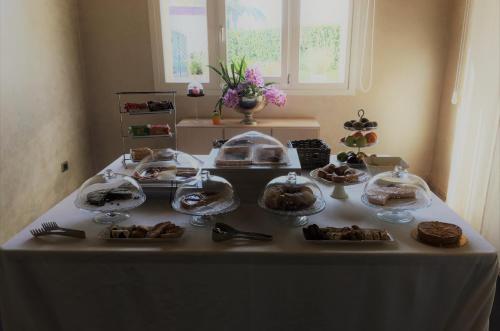 a table with plates of food on top of it at Archeo Hotel in Gela