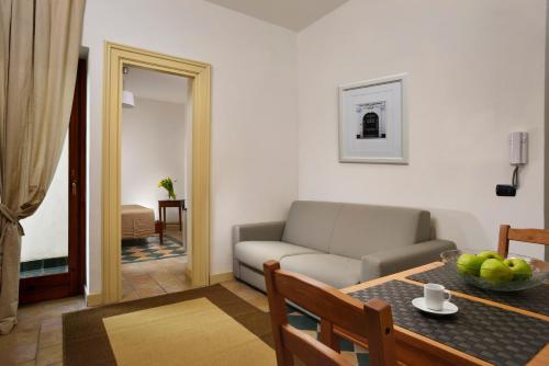 a living room with a couch and a table at Roma Resort Termini in Rome