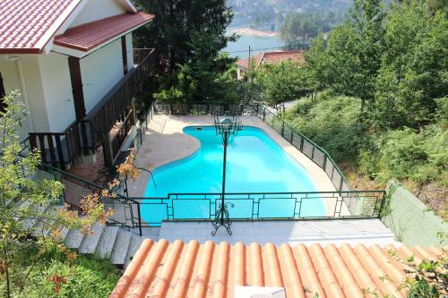 a view of a swimming pool from a house at Casa da Verdasca by Gerês Casas in Geres