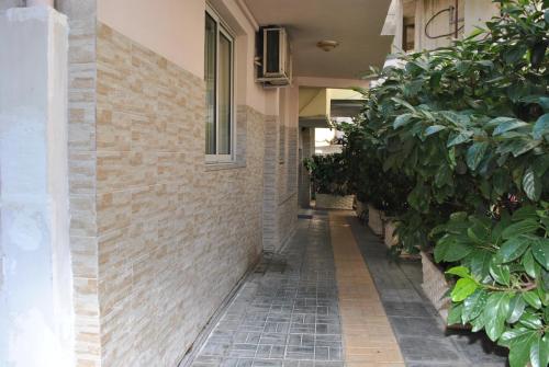 a brick hallway with plants on the side of a building at Hotel Freskia in Gjirokastër