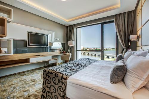 A bed or beds in a room at Merit Grand Mosta Spa Hotel & Casino