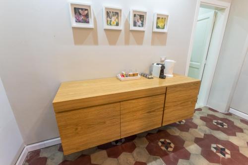 a wooden dresser in a room with pictures on the wall at Giardino Labruto in Messina