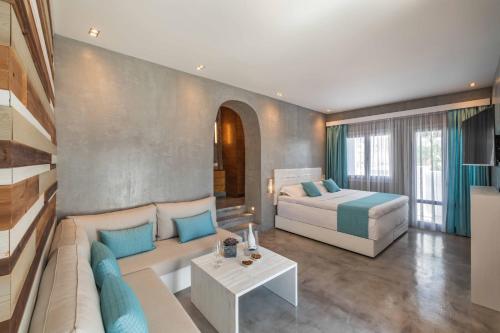 a bedroom with a bed and a couch in a room at Melangel in Mýkonos City