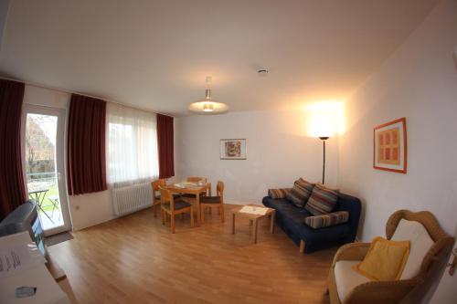 a living room with a couch and a table at Haus Marinus in Puttgarden