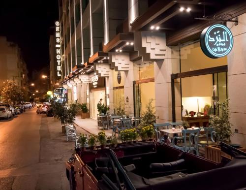 a restaurant on the side of a street at night at Gems Hotel in Beirut