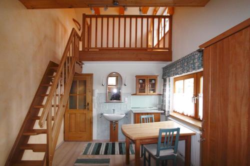 a kitchen with a dining room table and a staircase at Pension Wenger in Kirchheim im Innkreis