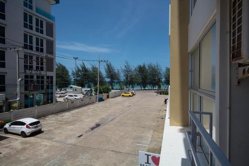 an empty street with a car parked on the side of a building at Avatara Condo B24 by malai in Mae Pim
