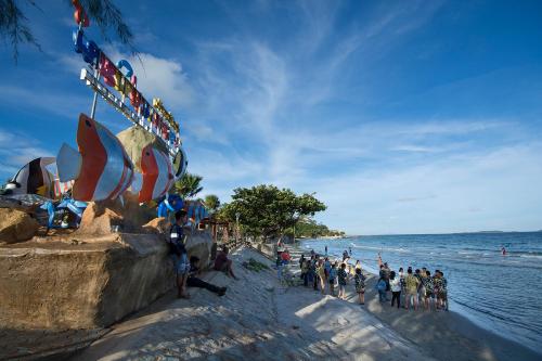 a group of people standing on the beach at Avatara Condo B24 by malai in Mae Pim