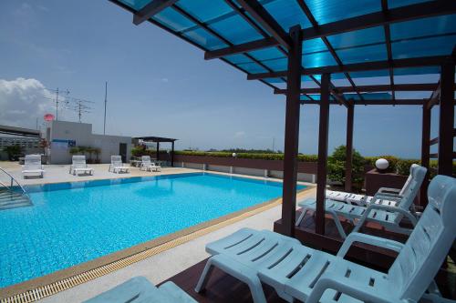 a swimming pool with lounge chairs and a swimming pool at Avatara Condo B24 by malai in Mae Pim