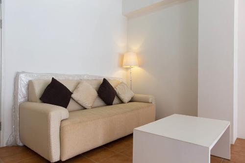 a living room with a couch and a table at Avatara Condo B24 by malai in Mae Pim