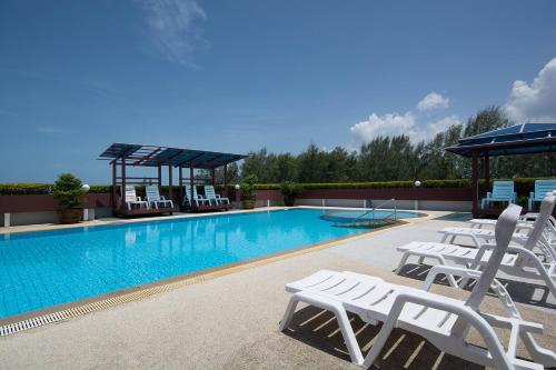 a swimming pool with white lounge chairs next to it at Avatara Condo B24 by malai in Mae Pim