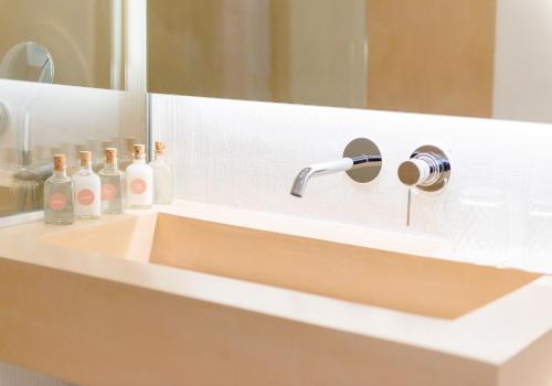 a bathroom sink with a faucet and a mirror at LLONGA'S 11th youth Hostel in Ciutadella