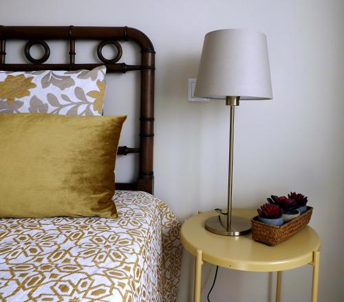 佩納菲耶爾的住宿－Casa Máximo，一间卧室配有一张床和一张桌子上的台灯