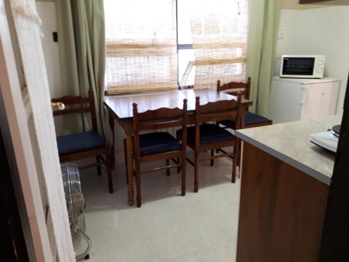 a kitchen with a dining room table and chairs at Hungarian Farmhouse in Zákányszék