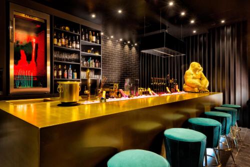 a bar with a teddy bear sitting at the counter at Hotel Palace Berlin in Berlin