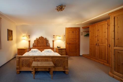 a bedroom with a large bed and wooden cabinets at Post Lech Arlberg in Lech am Arlberg