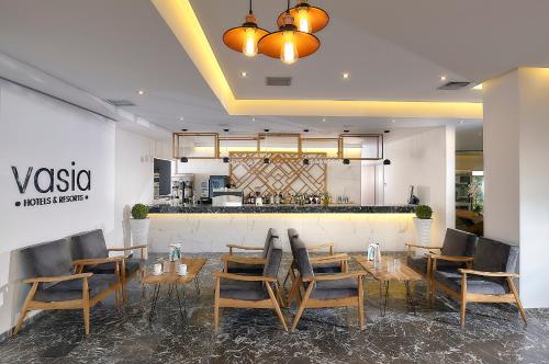 a restaurant with a table and chairs and a counter at Vasia Royal Hotel in Gouves
