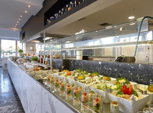 a buffet line in a restaurant with many plates of food at Vasia Royal Hotel in Gouves