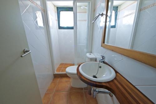 a bathroom with a toilet and a sink and a mirror at Bouganvilla in L'Ampolla