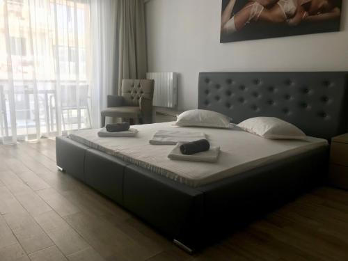 a large bed with two pillows on it in a bedroom at DeSilva Studios 46 & 47 in Mamaia