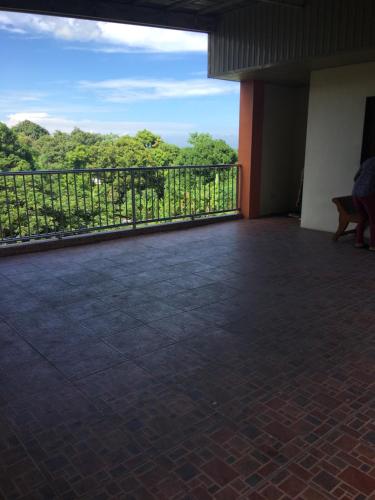 a balcony of a building with a view of trees at Affordable La Union in Caba