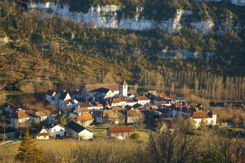 a small village on a hill with a church at Quercy Stone Gite Marcilhac in Marcilhac-sur-Célé