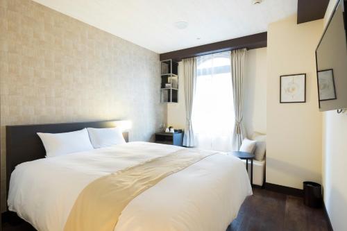 EN HOTEL Fujisawaにあるベッド