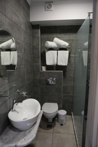 a bathroom with a sink and a toilet and towels at Aphrodite in Keramotí