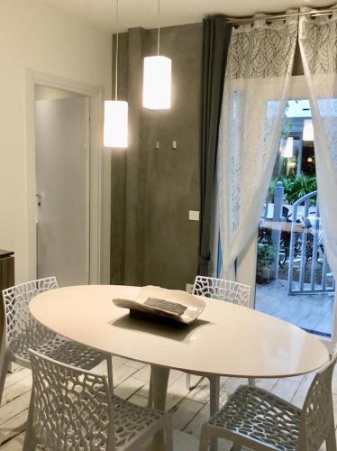 a table and chairs with a book on top of it at Appartamenti Barzilai in Gabicce Mare