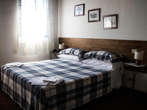 a bedroom with a bed with two pillows on it at Locanda Casa Motta in Poviglio