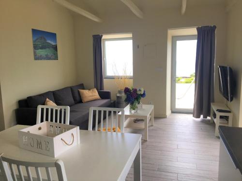 a living room with a couch and a table at Casa do Almance in São João