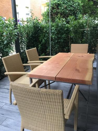 a wooden table and chairs on a patio at Appartamenti Barzilai in Gabicce Mare