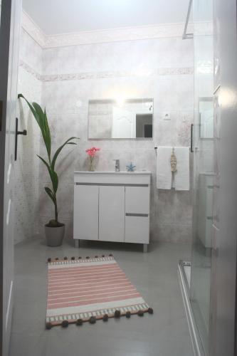 a bathroom with a sink and a mirror at Flipflops Ocean View in Nazaré