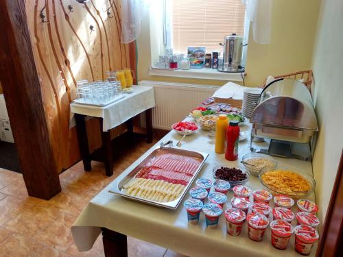 a table with a bunch of food on it at Penzión Víchrica in Veľká Lomnica