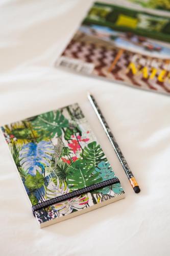 a notebook and a pen on a table at Hôtel & Spa Villa Seren in Hossegor