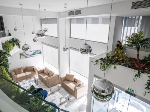 an overhead view of a living room with couches and plants at Frangiorgio Hotel in Larnaka