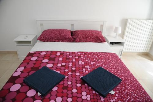 a bedroom with a bed with red and pink polka dots at Palazzo Grigio in Bari