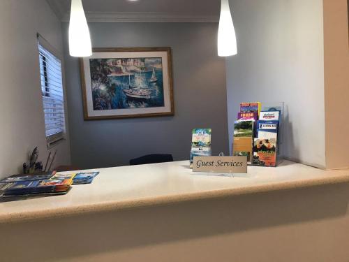 a counter with books on top of a desk at Colony Club Inn & Suites in Nassau