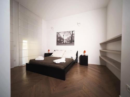 a bedroom with a bed and a staircase at Turati 3 in Milan
