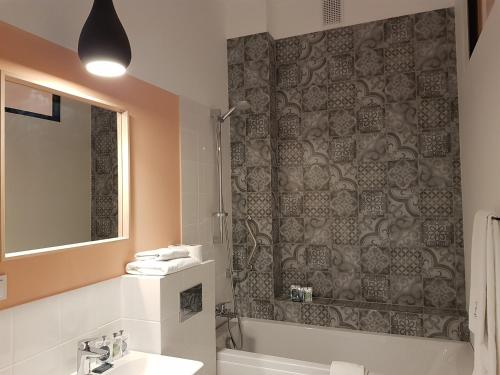 a bathroom with a tub and a sink and a shower at Hotel Fado Spa & Restaurant in Świdnica