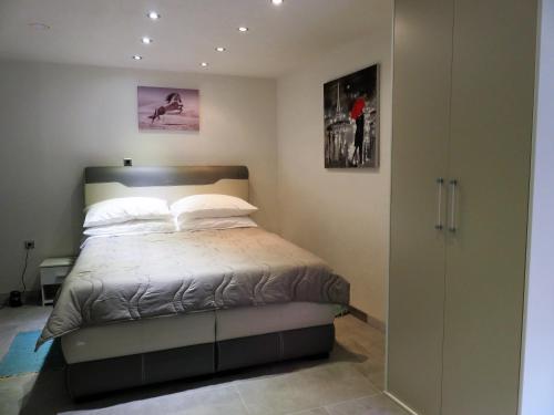 a bedroom with a bed and a sliding glass door at Apartman in Cres