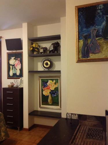 a living room with vases on shelves and a fireplace at Affittacamere Alle 5 Terre in Monterosso al Mare