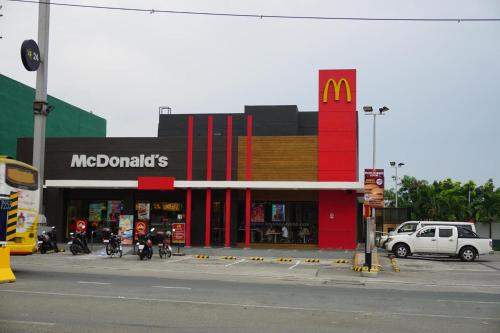 a mcdonalds fast food restaurant with a car parked outside at XNY at SMDC Trees Residences Quezon City-1 Bed RoomT2 in Manila