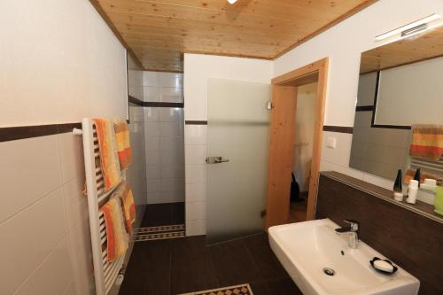 a bathroom with a sink and a mirror at Gasthof Beim Endeler in Missen-Wilhams