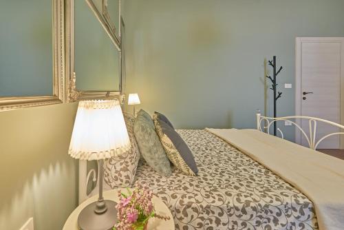 a bedroom with a bed with a lamp on a table at Old City Romanitic Studios 1 with FREE private parking in Pula