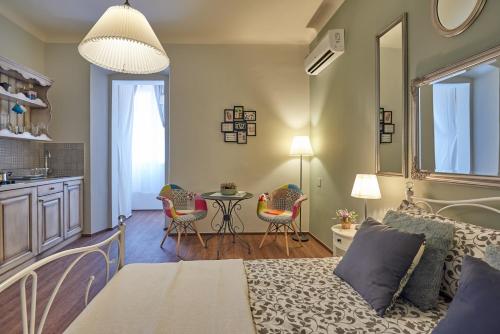 a bedroom with a bed and a table and chairs at Old City Romanitic Studios 1 with FREE private parking in Pula