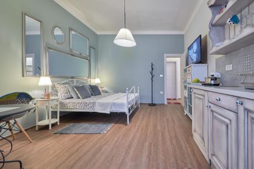 a bedroom with a bed and a kitchen with a table at Old City Romanitic Studios 1 with FREE private parking in Pula