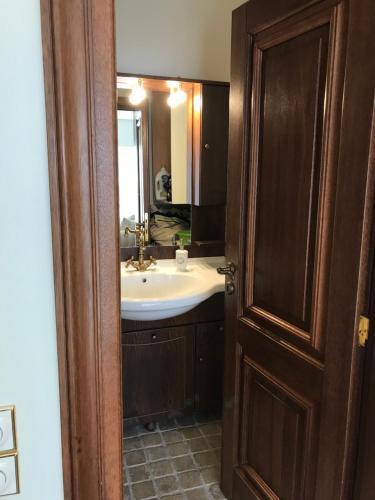 a bathroom with a sink and a mirror at Bella's Rustic Suites in Nafplio