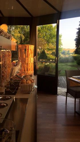 a kitchen with a counter with a view of a patio at Kyriad Angoulême Nord Champniers- Hôtel & Résidence in Champniers
