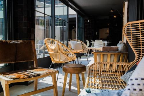 a group of chairs and tables on a patio at Rock Noir & Spa in La Salle-les-Alpes
